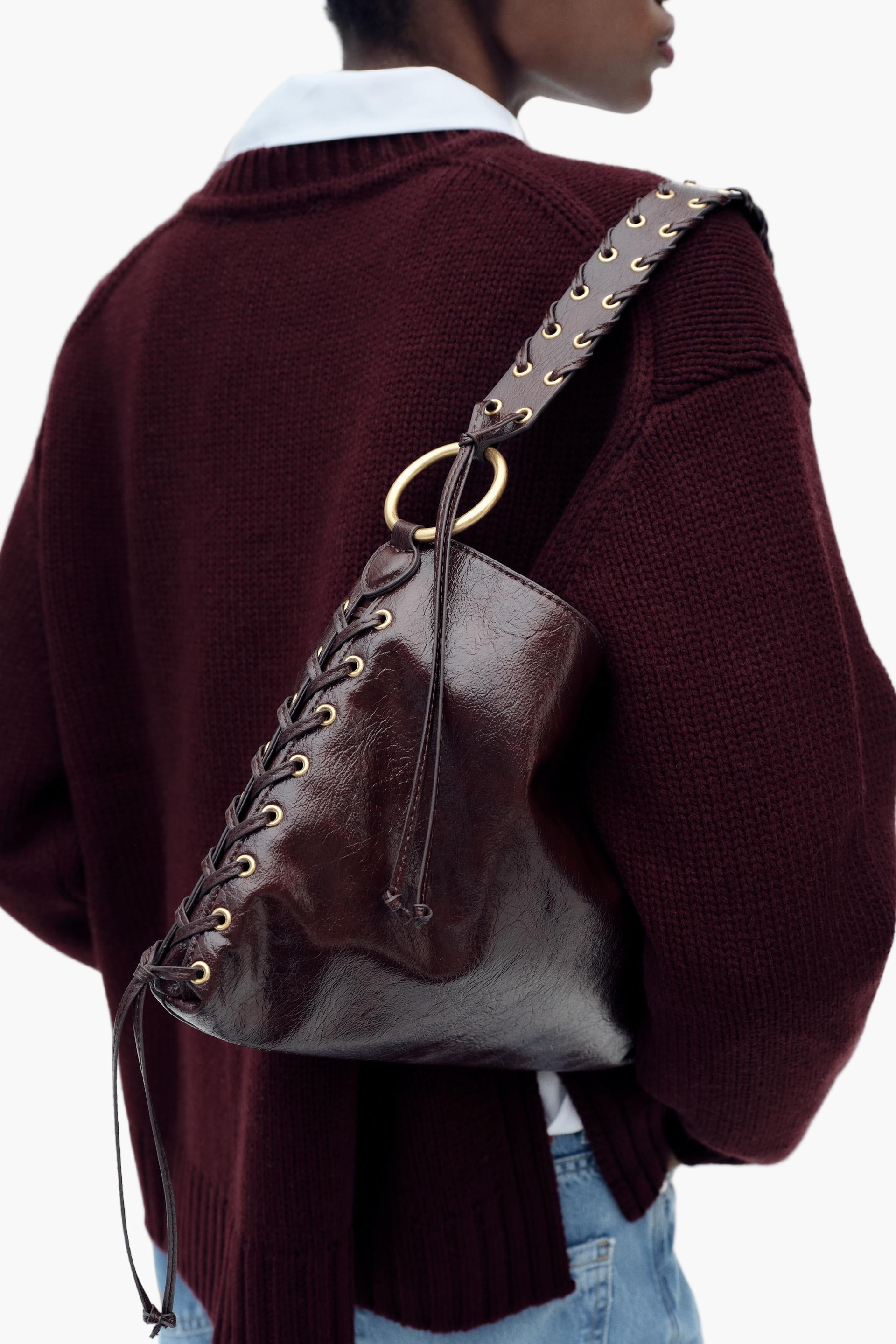 Brown structured vegan leather bag worn under arm – casual chic look”