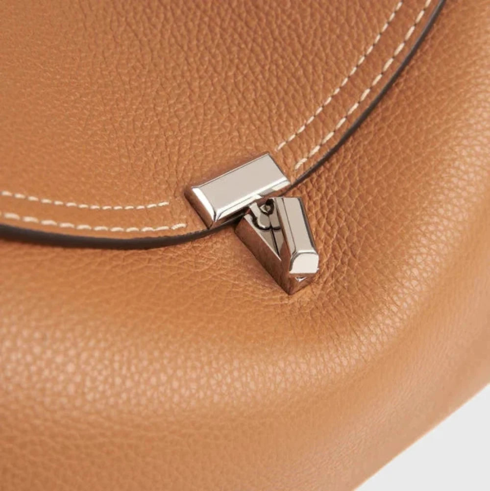 gold lock closure arc flap structured handbag detail women