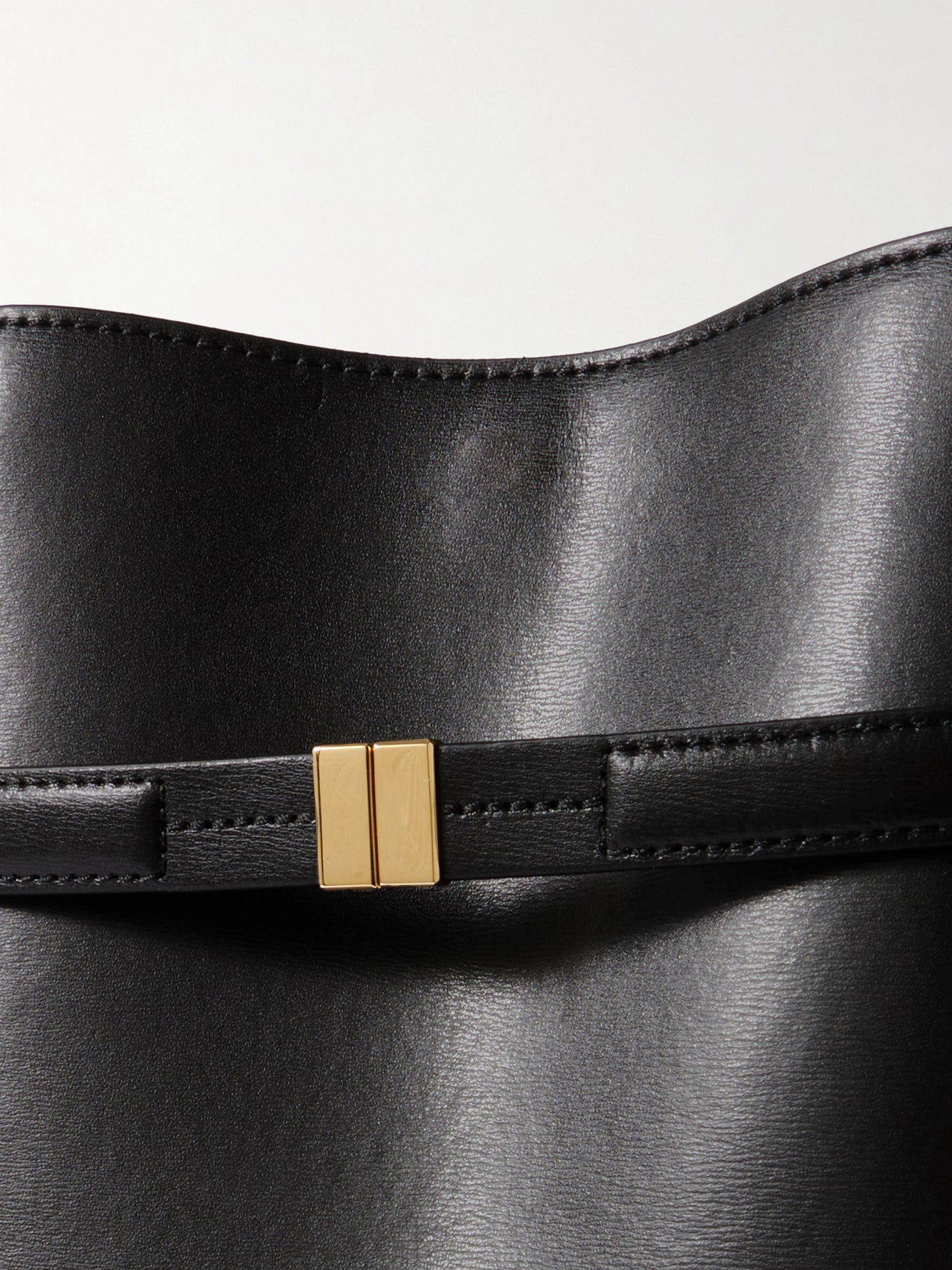 black bucket bag gold hardware detail women leather close up