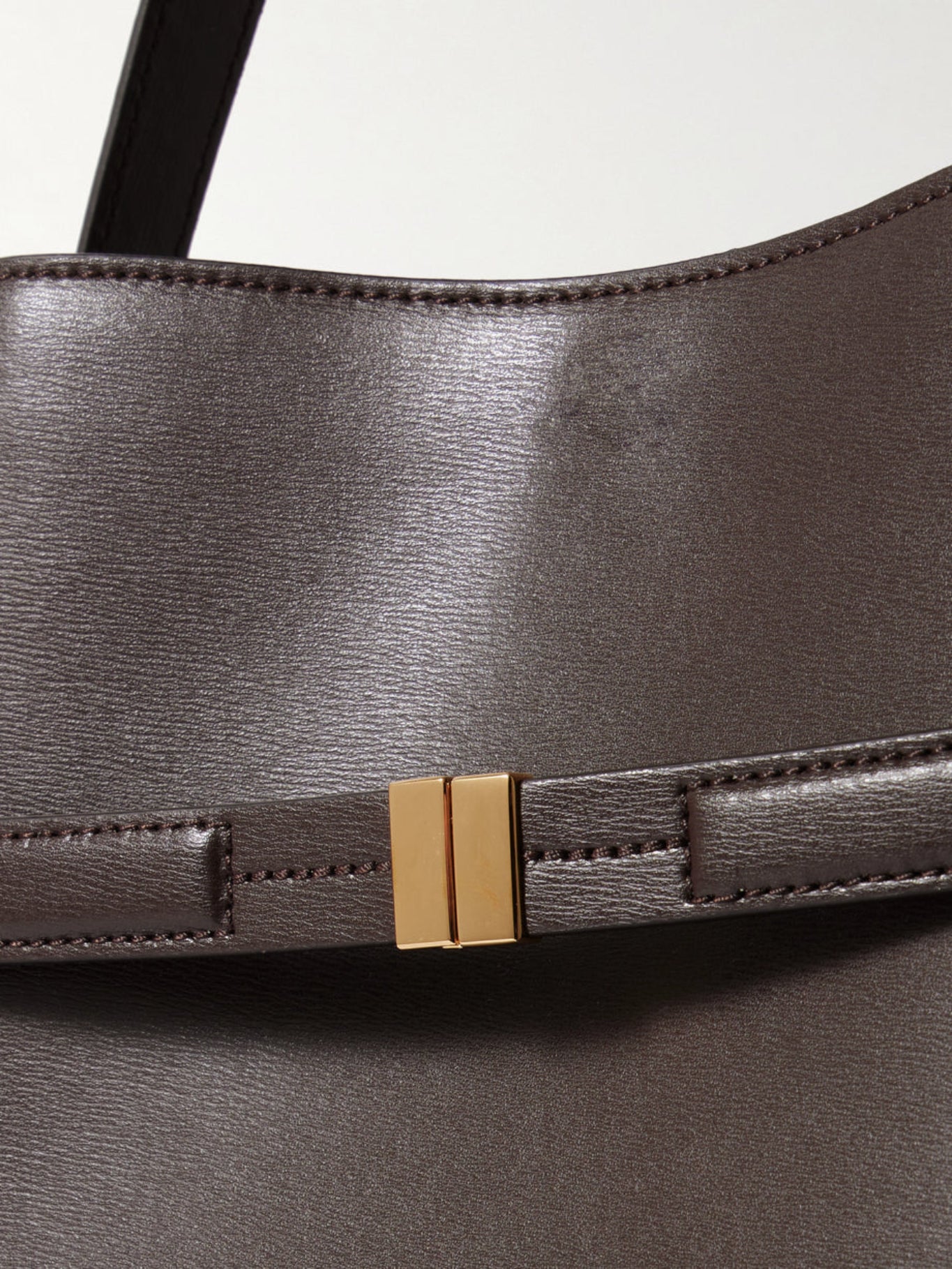 dark brown bucket bag gold hardware detail women leather close up