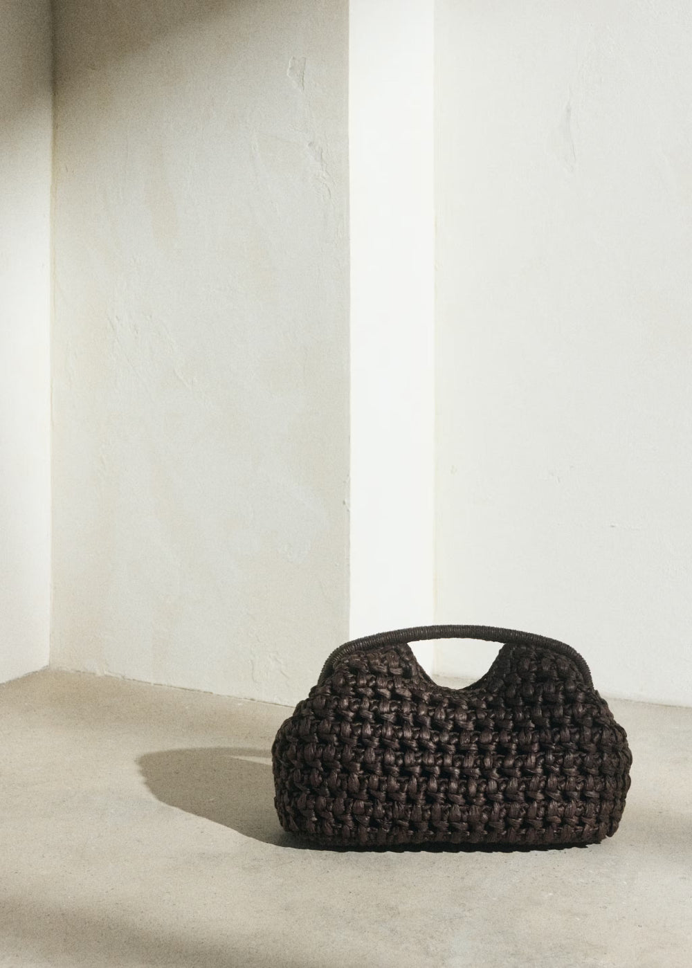 brown crochet clutch bag lifestyle minimal interior setting - brown - clutch bag